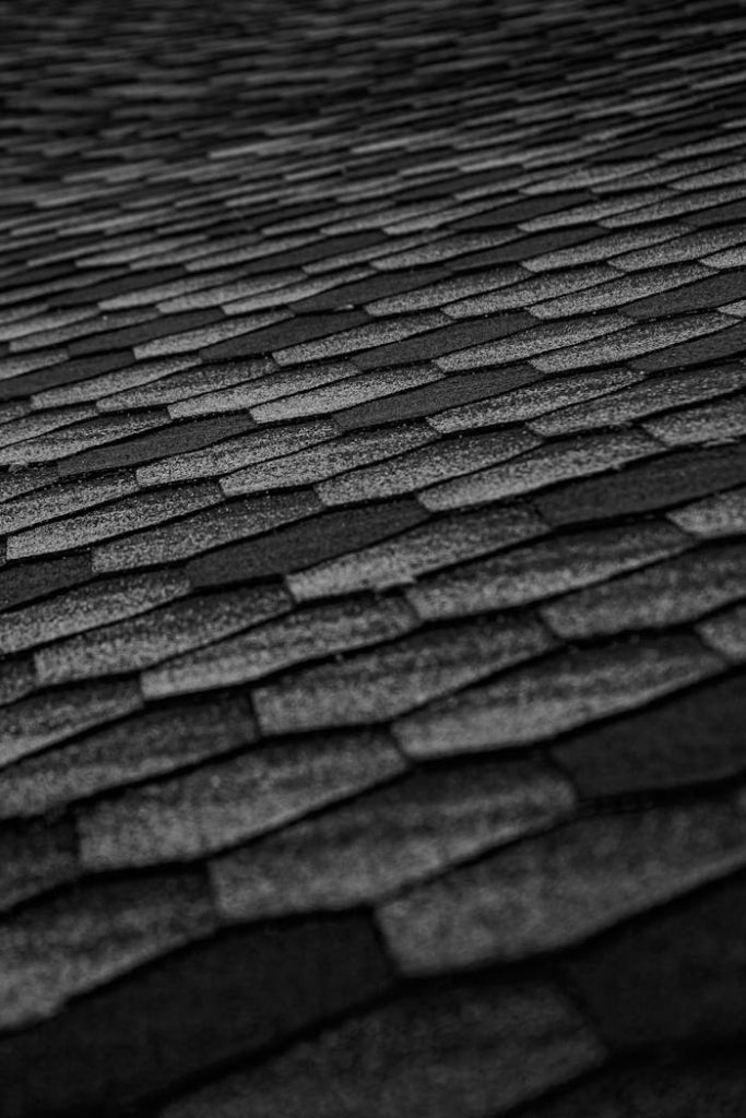 pexels-photo-4334097 Close-up of black roof shingles forming an abstract textured pattern, emphasizing geometry and modern architecture.